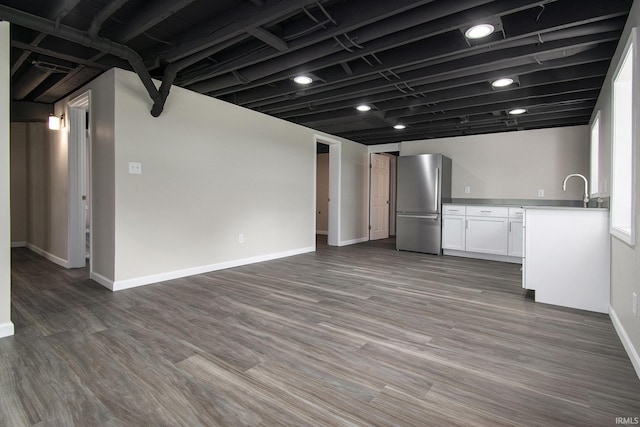 10974 County Road 10, Middlebury, IN 46540 - kitchen with freestanding refrigerator, baseboards, white cabinetry, wood finished floors, and light countertops