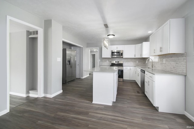10974 County Road 10, Middlebury, IN 46540 - kitchen featuring stainless steel appliances, a sink, backsplash, baseboards, and light countertops