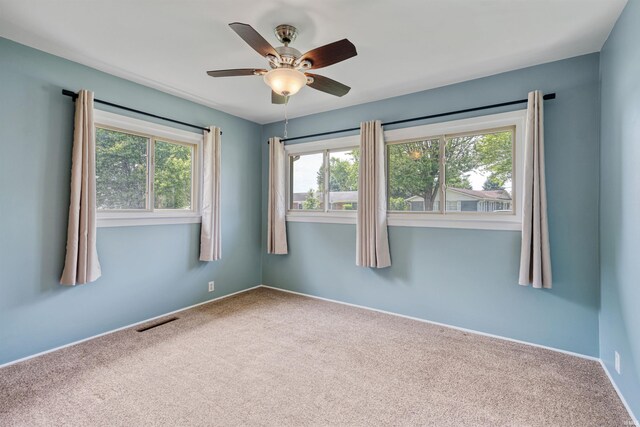 1300 Belvedere Dr, Kokomo, IN 46902 - spare room featuring plenty of natural light, carpet, and a ceiling fan