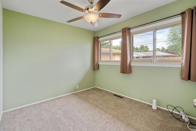 1300 Belvedere Dr, Kokomo, IN 46902 - spare room with carpet flooring, a ceiling fan, and baseboards