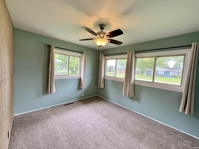 1300 Belvedere Dr, Kokomo, IN 46902 - empty room with carpet floors, a ceiling fan, and baseboards