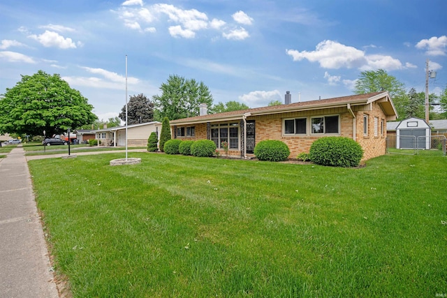 1300 Belvedere Dr, Kokomo, IN 46902 - view of front facade featuring a front yard, brick siding, and a chimney
