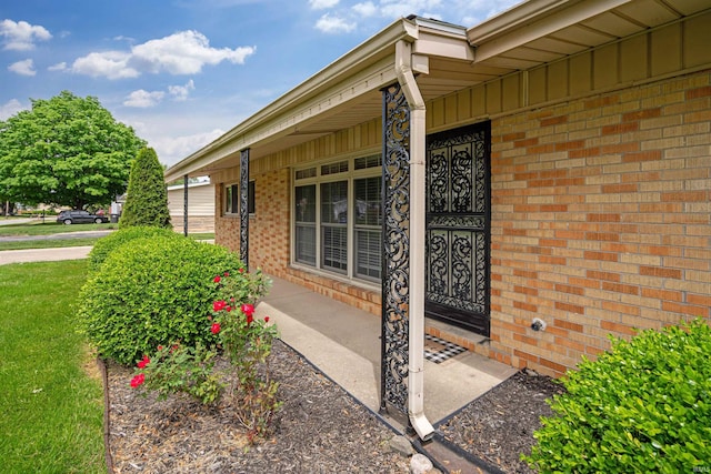 1300 Belvedere Dr, Kokomo, IN 46902 - doorway to property featuring brick siding, a porch, and board and batten siding