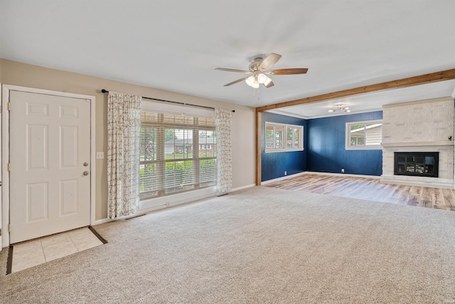 1300 Belvedere Dr, Kokomo, IN 46902 - unfurnished living room featuring carpet floors, a ceiling fan, baseboards, and a fireplace