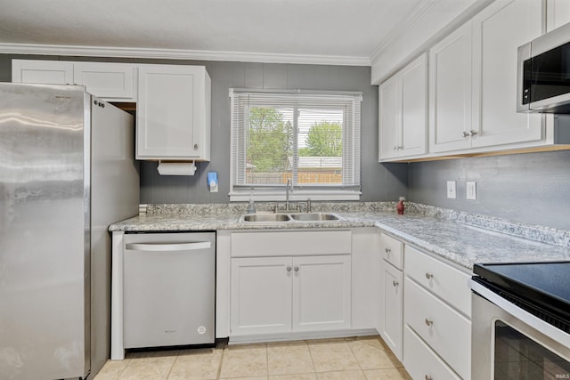 1300 Belvedere Dr, Kokomo, IN 46902 - kitchen featuring appliances with stainless steel finishes, a sink, ornamental molding, white cabinets, and light countertops