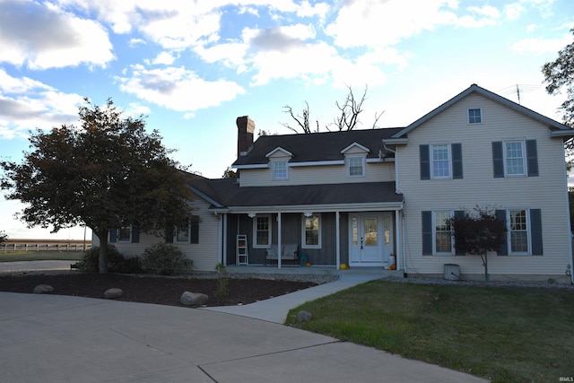 7019 Bull Rapids Rd, Woodburn, IN 46797 - view of front of property with a porch, a chimney, and a front lawn