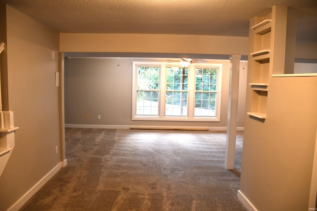 7019 Bull Rapids Rd, Woodburn, IN 46797 - carpeted spare room featuring baseboards, ceiling fan, a textured ceiling, and built in shelves