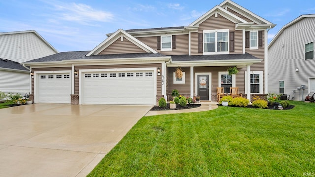 5263 Gadwall Pass, Fort Wayne, IN 46818 - view of front of house featuring driveway, a front lawn, covered porch, and an attached garage