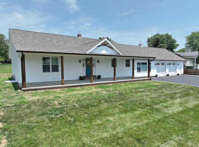 1412 E National Hwy, Washington, IN 47501 - modern inspired farmhouse featuring covered porch, a front yard, and a chimney