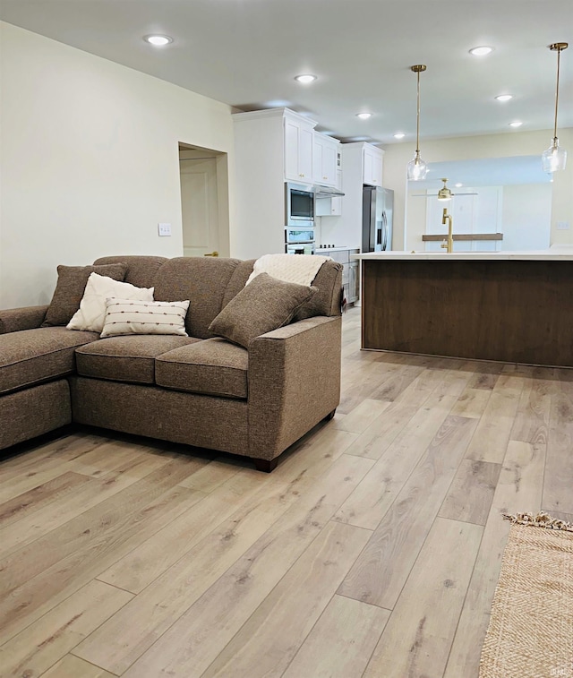 1412 E National Hwy, Washington, IN 47501 - living area featuring light wood-style flooring and recessed lighting