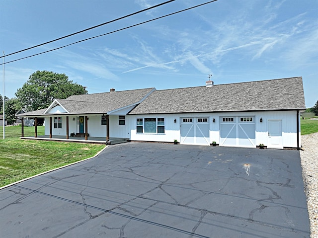 1412 E National Hwy, Washington, IN 47501 - view of front of property featuring asphalt driveway, a porch, a front yard, and a garage