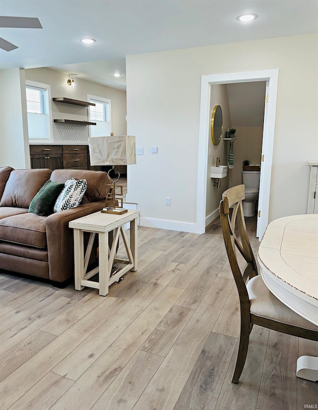1412 E National Hwy, Washington, IN 47501 - living area featuring light wood finished floors, recessed lighting, baseboards, and ceiling fan
