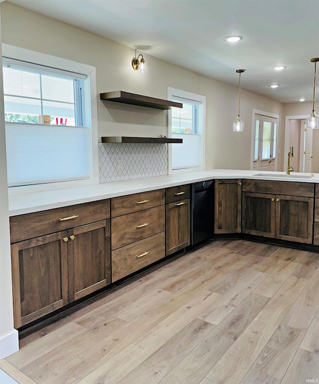 1412 E National Hwy, Washington, IN 47501 - kitchen featuring open shelves, dishwasher, light wood-style flooring, a sink, and decorative light fixtures
