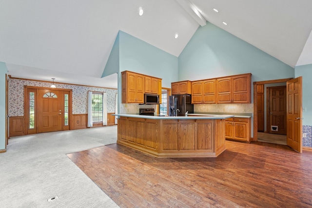 1395 E 75 N, Lagrange, IN 46761 - kitchen with high vaulted ceiling, appliances with stainless steel finishes, light wood-style flooring, beam ceiling, and light countertops