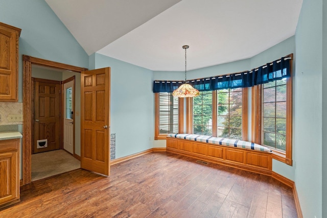 1395 E 75 N, Lagrange, IN 46761 - unfurnished dining area featuring wood finished floors, baseboards, and vaulted ceiling