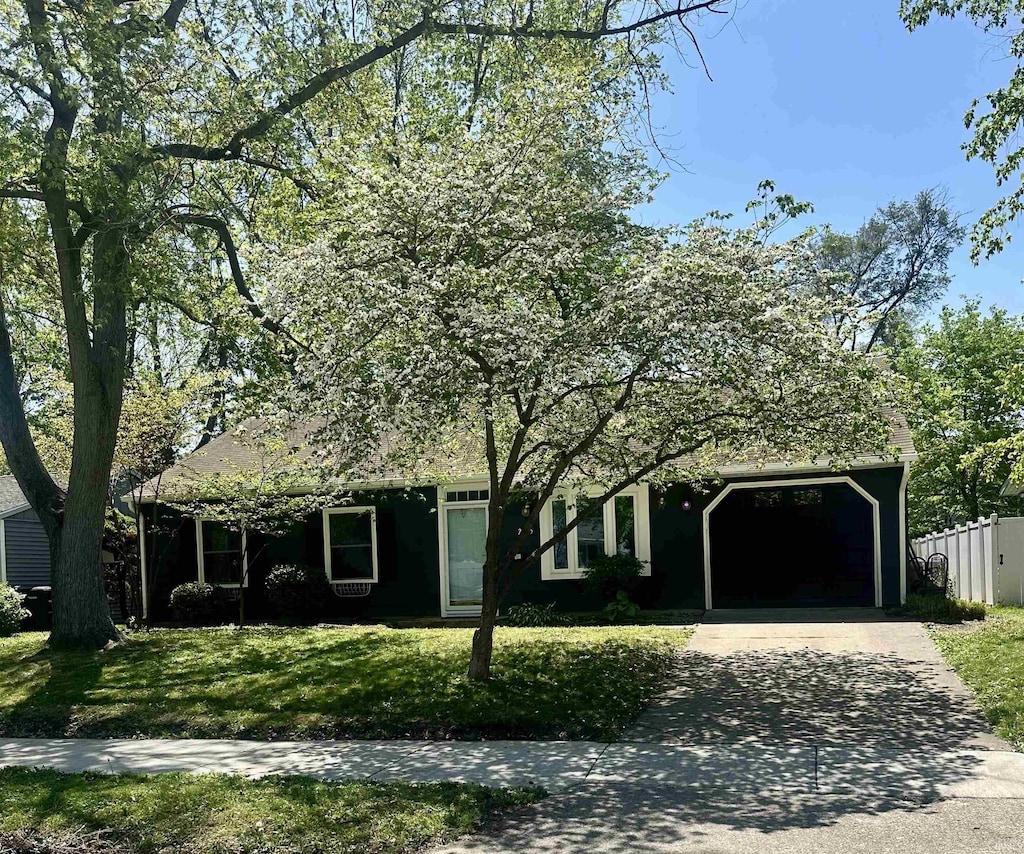 2405 Iroquois Trl, Lafayette, IN 47909 - view of front of property featuring driveway, a front lawn, and an attached garage