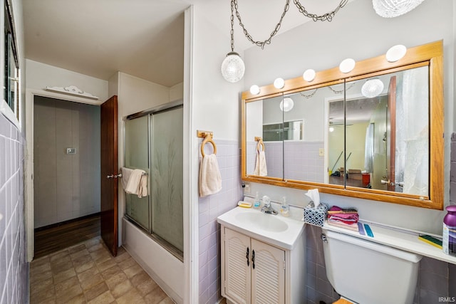 1212 Michigan Ave, Mishawaka, IN 46544 - full bath featuring toilet, combined bath / shower with glass door, vanity, and tile walls