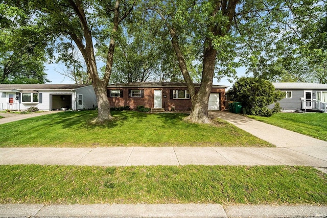 1212 Michigan Ave, Mishawaka, IN 46544 - single story home featuring an attached garage, concrete driveway, a front yard, and brick siding