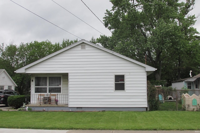 1908 E 18th St, Muncie, IN 47302 - view of home's exterior featuring covered porch, a yard, and crawl space
