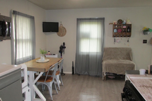 1908 E 18th St, Muncie, IN 47302 - dining space with light wood-style flooring and baseboards
