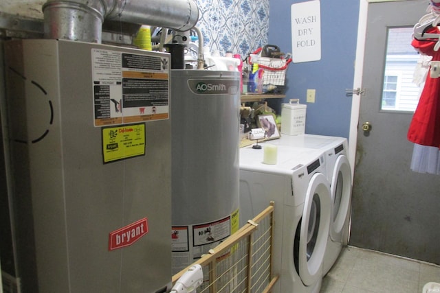 1908 E 18th St, Muncie, IN 47302 - laundry room with washer and clothes dryer, light tile patterned floors, and gas water heater
