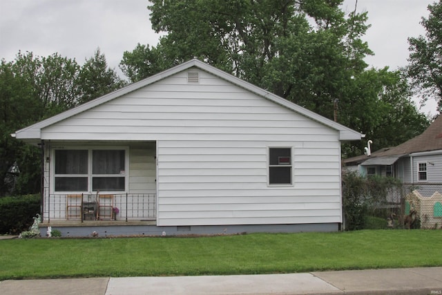 1908 E 18th St, Muncie, IN 47302 - view of property exterior with covered porch and a lawn