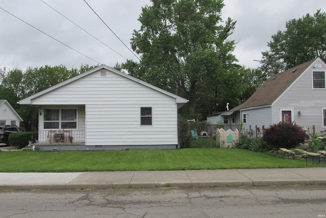 1908 E 18th St, Muncie, IN 47302 - view of home's exterior with a lawn, a porch, and crawl space