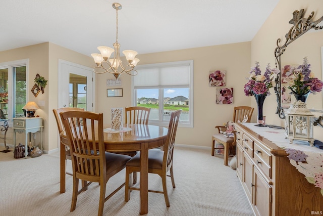 3441 Brantley Dr, New Haven, IN 46774 - dining room featuring light colored carpet, a chandelier, and baseboards