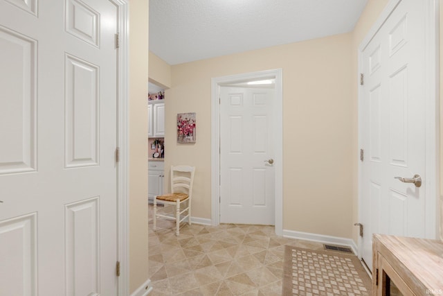 3441 Brantley Dr, New Haven, IN 46774 - hall featuring baseboards, a textured ceiling, and light tile patterned floors