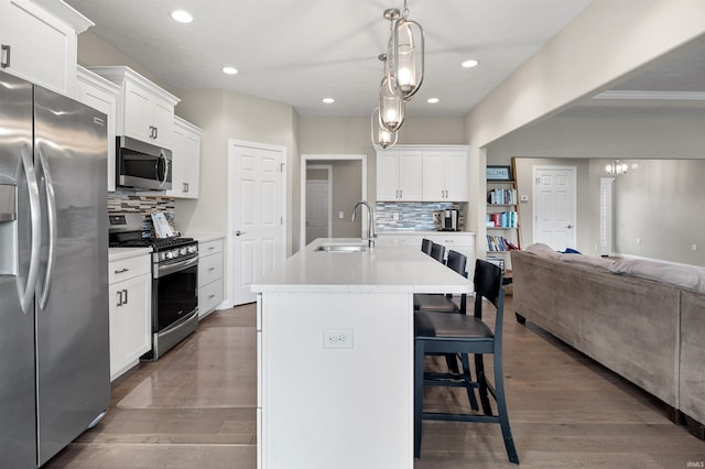 1159 Chesapeake Pointe Dr, Lafayette, IN 47909 - kitchen with stainless steel appliances, a sink, open floor plan, tasteful backsplash, and recessed lighting
