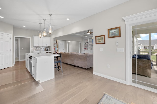 1159 Chesapeake Pointe Dr, Lafayette, IN 47909 - kitchen with open floor plan, a sink, light countertops, white cabinetry, and a breakfast bar area