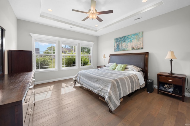 1159 Chesapeake Pointe Dr, Lafayette, IN 47909 - bedroom featuring a raised ceiling, wood finished floors, baseboards, recessed lighting, and ceiling fan