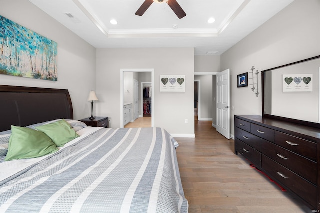 1159 Chesapeake Pointe Dr, Lafayette, IN 47909 - bedroom featuring a tray ceiling, light wood finished floors, a ceiling fan, baseboards, and recessed lighting