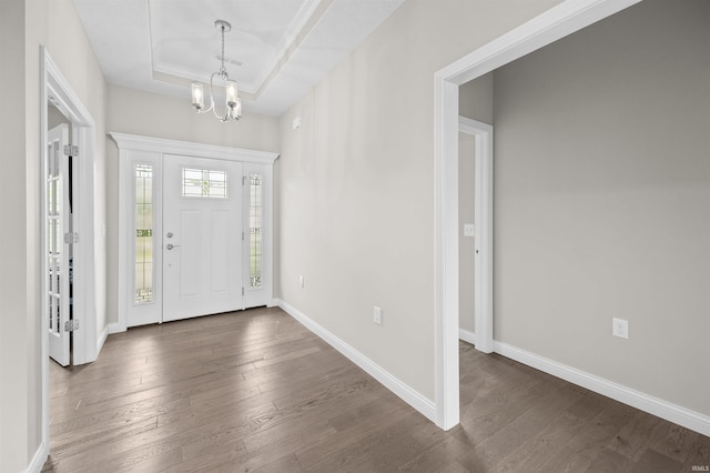 1159 Chesapeake Pointe Dr, Lafayette, IN 47909 - foyer entrance featuring dark wood-style flooring, a tray ceiling, a chandelier, and baseboards