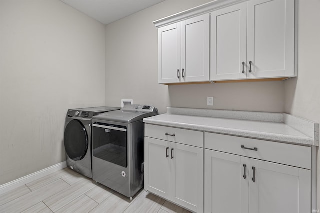 1159 Chesapeake Pointe Dr, Lafayette, IN 47909 - laundry room featuring washing machine and dryer, cabinet space, and baseboards