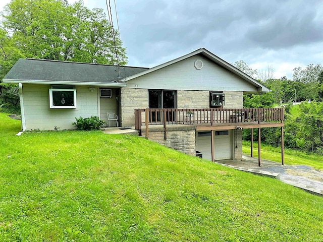 302 S Edgewood Dr, Ellettsville, IN 47429 - rear view of house featuring an attached garage, a wooden deck, a yard, and driveway