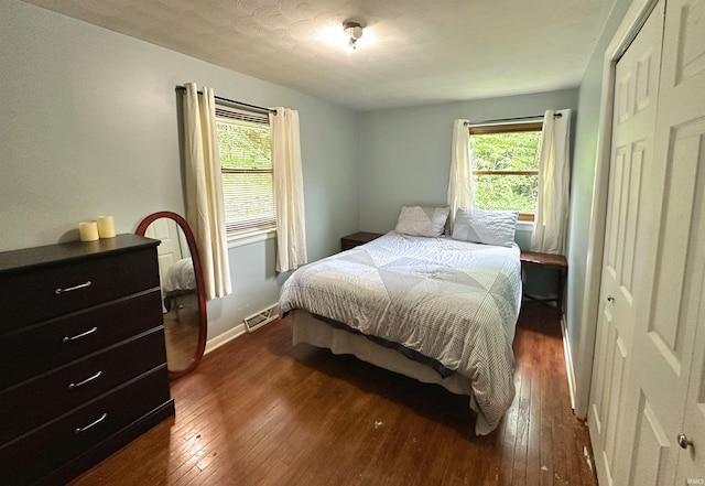 302 S Edgewood Dr, Ellettsville, IN 47429 - bedroom with dark wood finished floors, a closet, and baseboards