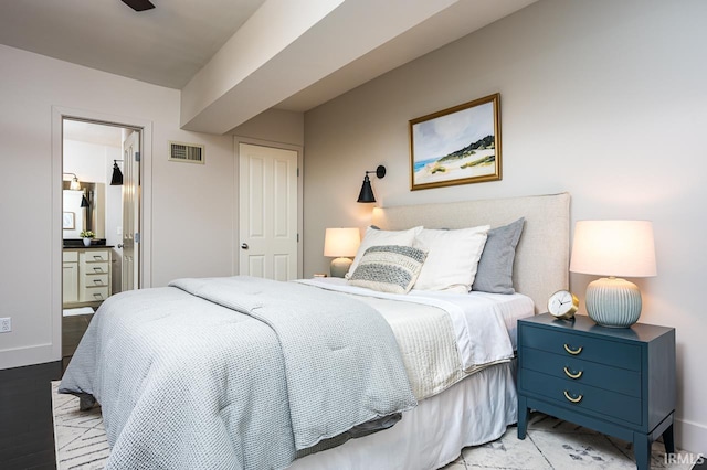 112 W Washington Blvd Unit 232, Fort Wayne, IN 46802 - bedroom featuring baseboards, ensuite bath, and wood finished floors