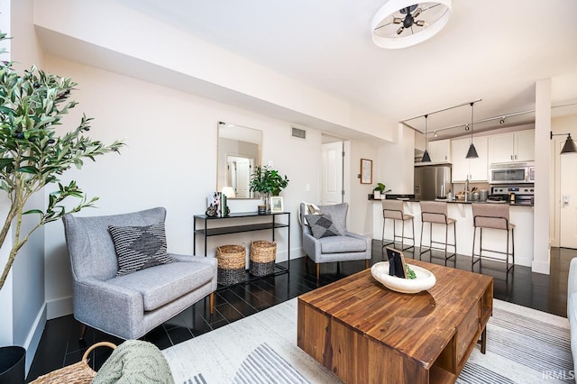 112 W Washington Blvd Unit 232, Fort Wayne, IN 46802 - living area with dark wood-style floors, baseboards, and track lighting