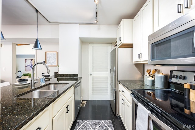 112 W Washington Blvd Unit 232, Fort Wayne, IN 46802 - kitchen with appliances with stainless steel finishes, a sink, dark stone counters, hanging light fixtures, and white cabinets