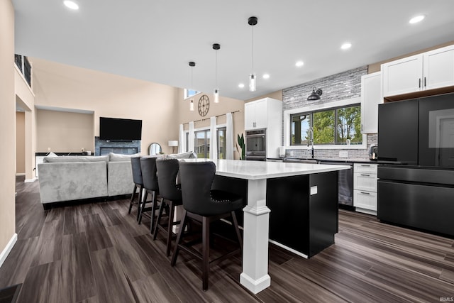 30474 Jaxon Dr, Elkhart, IN 46517 - kitchen featuring stainless steel appliances, a kitchen island, recessed lighting, tasteful backsplash, and white cabinetry