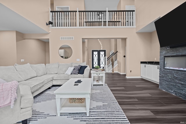 30474 Jaxon Dr, Elkhart, IN 46517 - living room with a towering ceiling, dark wood-style floors, stairs, and baseboards