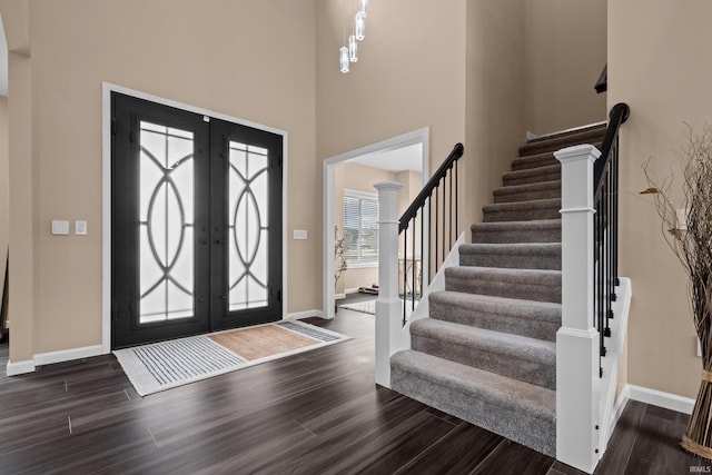 30474 Jaxon Dr, Elkhart, IN 46517 - entryway featuring dark wood finished floors, stairway, baseboards, and a high ceiling