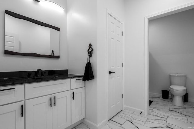 30474 Jaxon Dr, Elkhart, IN 46517 - bathroom featuring marble finish flooring, vanity, baseboards, and toilet