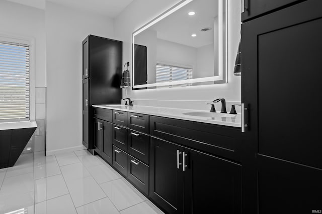 30474 Jaxon Dr, Elkhart, IN 46517 - bathroom with double vanity, baseboards, and tile patterned flooring