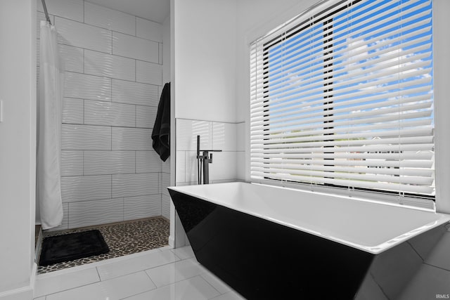 30474 Jaxon Dr, Elkhart, IN 46517 - full bath with a tile shower, a freestanding tub, and tile patterned flooring