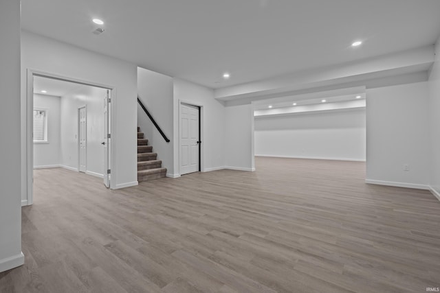 30474 Jaxon Dr, Elkhart, IN 46517 - unfurnished living room with stairway, recessed lighting, wood finished floors, and baseboards