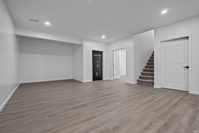 30474 Jaxon Dr, Elkhart, IN 46517 - below grade area with stairway, recessed lighting, wood finished floors, and baseboards