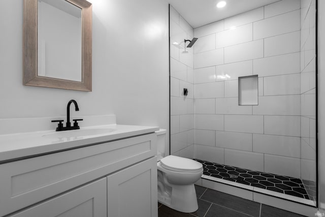 30474 Jaxon Dr, Elkhart, IN 46517 - bathroom featuring toilet, vanity, tiled shower, recessed lighting, and tile patterned flooring