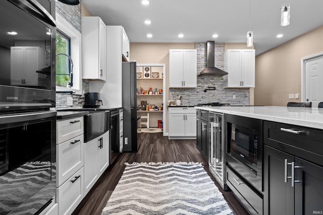 30474 Jaxon Dr, Elkhart, IN 46517 - kitchen featuring wall chimney exhaust hood, black appliances, backsplash, white cabinetry, and recessed lighting